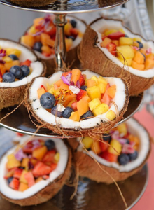 split coconut bowls filled with fruits