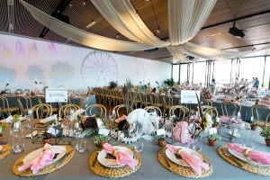function with set tables and pink bouquets