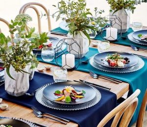 Set table with blue ombre linen and marble vases