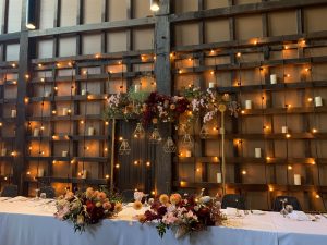 Rustic wedding backdrop with hanging globev lights