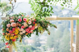 Flower arrangement on top of wedding arches